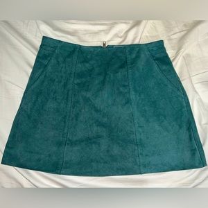 Kendall and Kylie Swede green mini skirt.